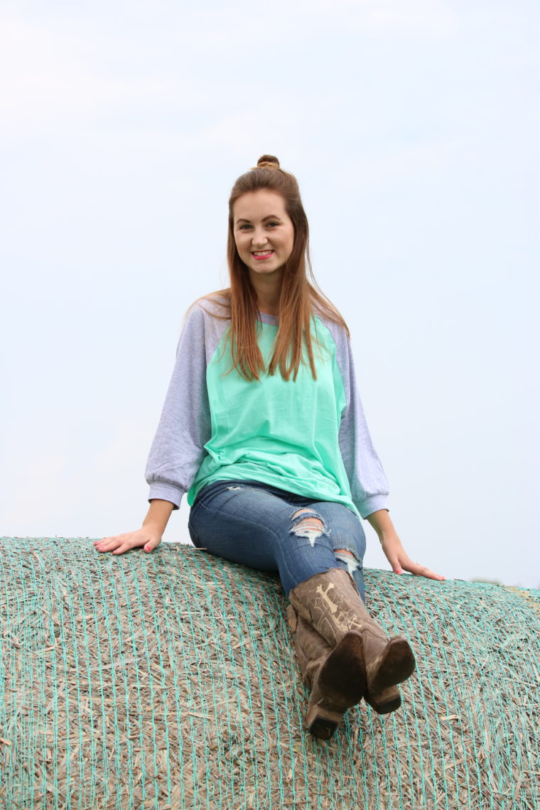 mint sweater, top knot, cowgirl boots, denim jeans