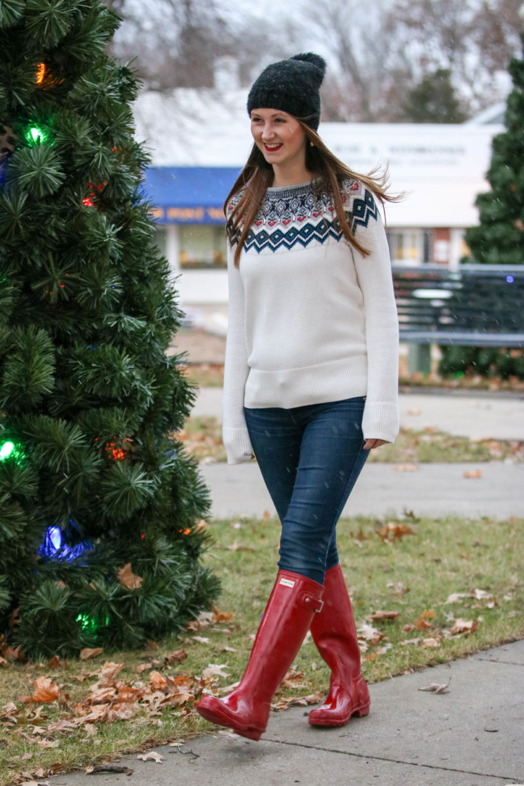 red hunter boots, holiday look, embellished sweater, black beanie