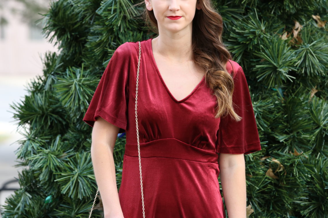 burgundy velvet dress, gold envelope clutch. holiday style