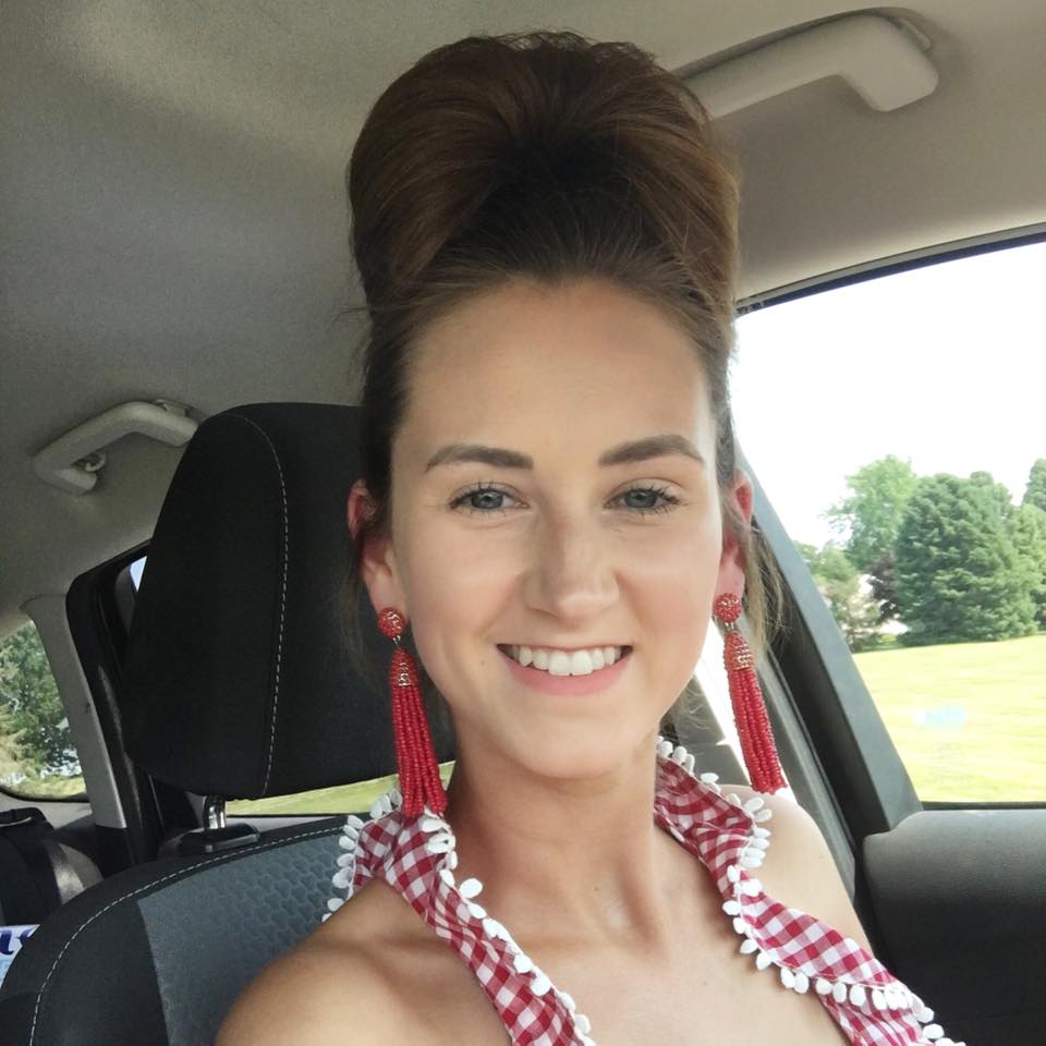 car selfie, red tassel earrings, bun