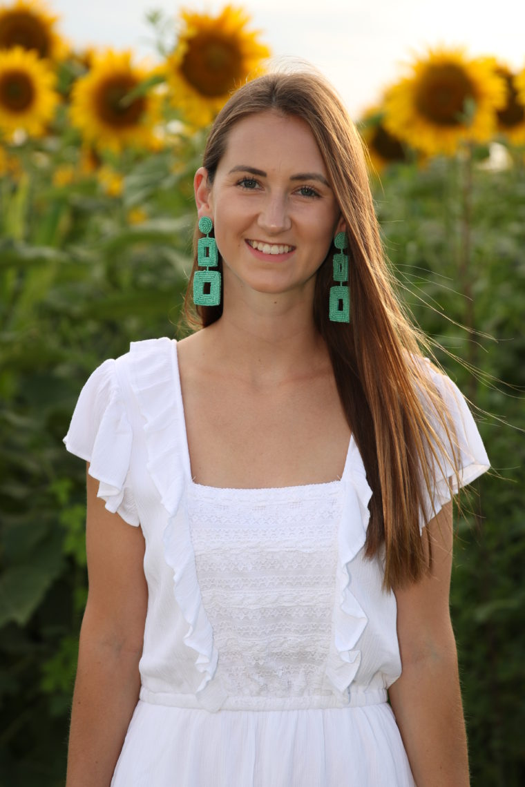 white ruffle romper, sunflower field, statement earrings