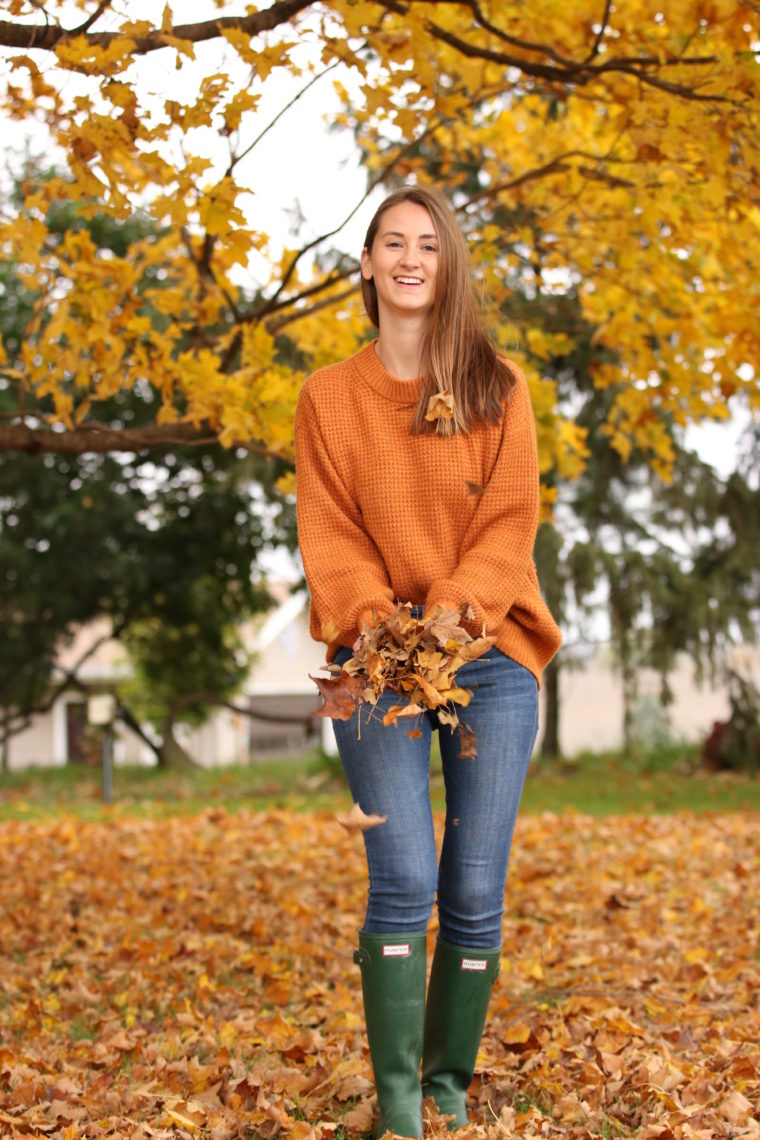 orange sweater, green hunter boots, yellow leaves 