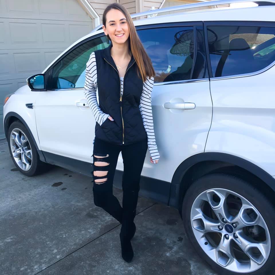 striped tee, black quilted vest, black over the knee boots