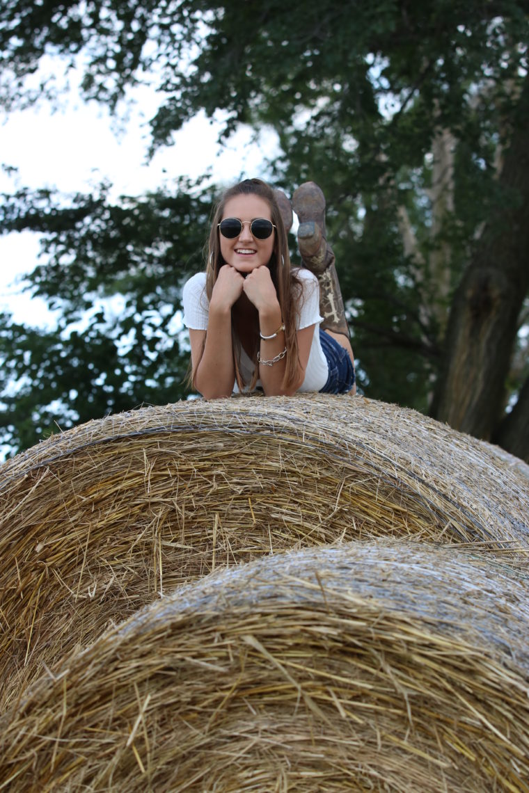 round sunglasses, hay bail, country girl