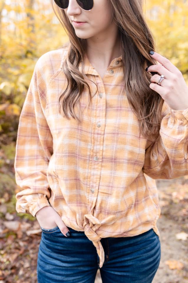 yellow plaid top, round sunglasses, curly hair