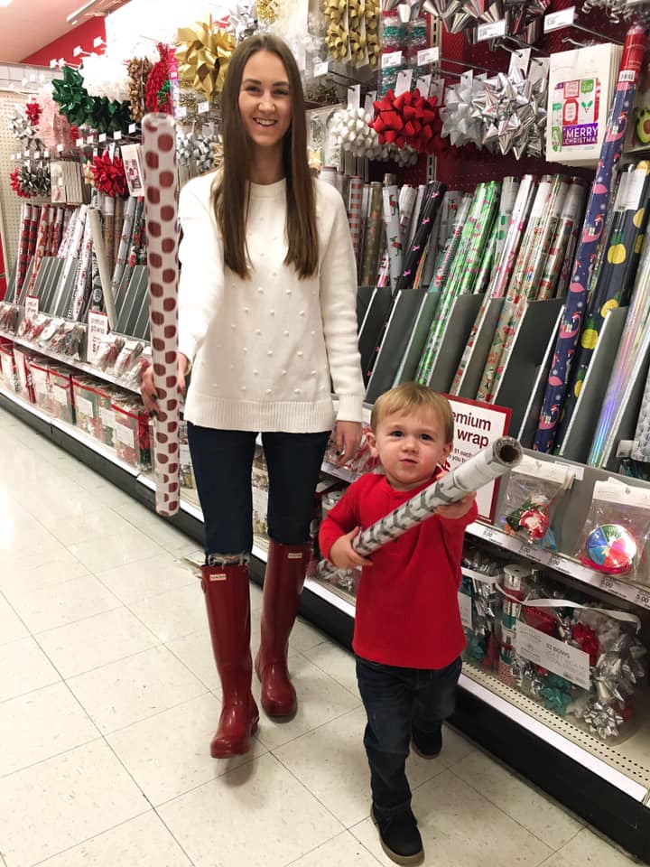pom pom sweater, red Hunter boots, wrapping paper