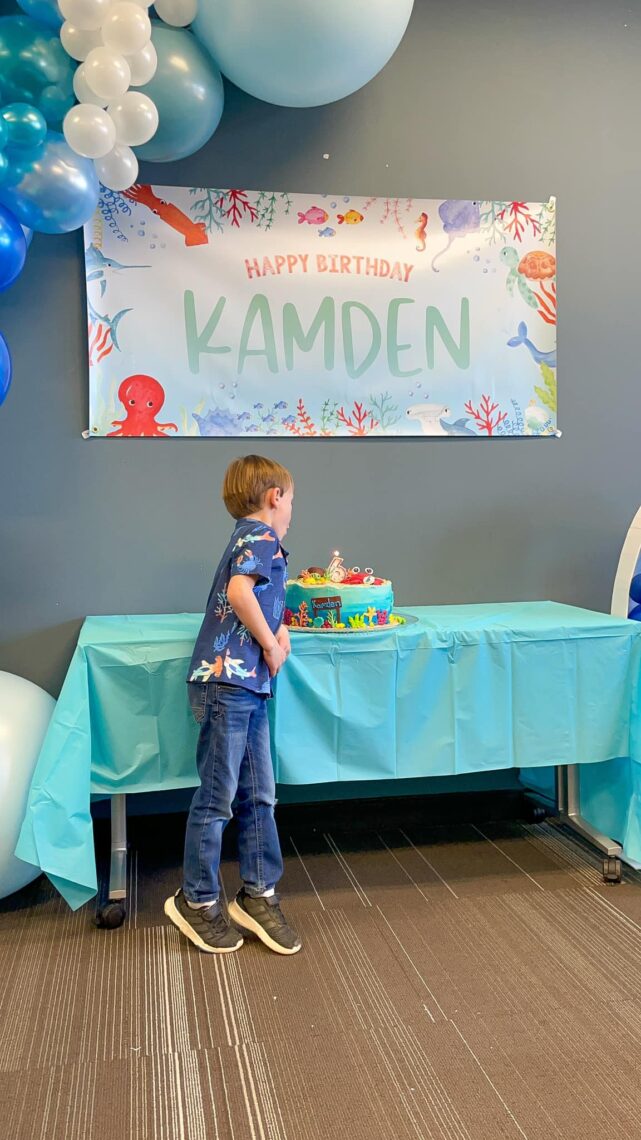 Boy blowing out his birthday candles. 