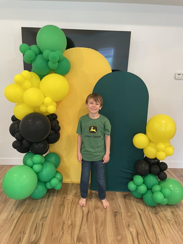 green, black, and yellow balloon garland