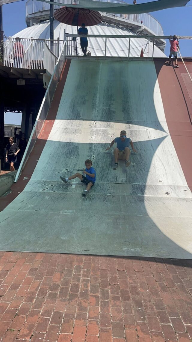 Father and son going down slide at the St. Louis City Museum.