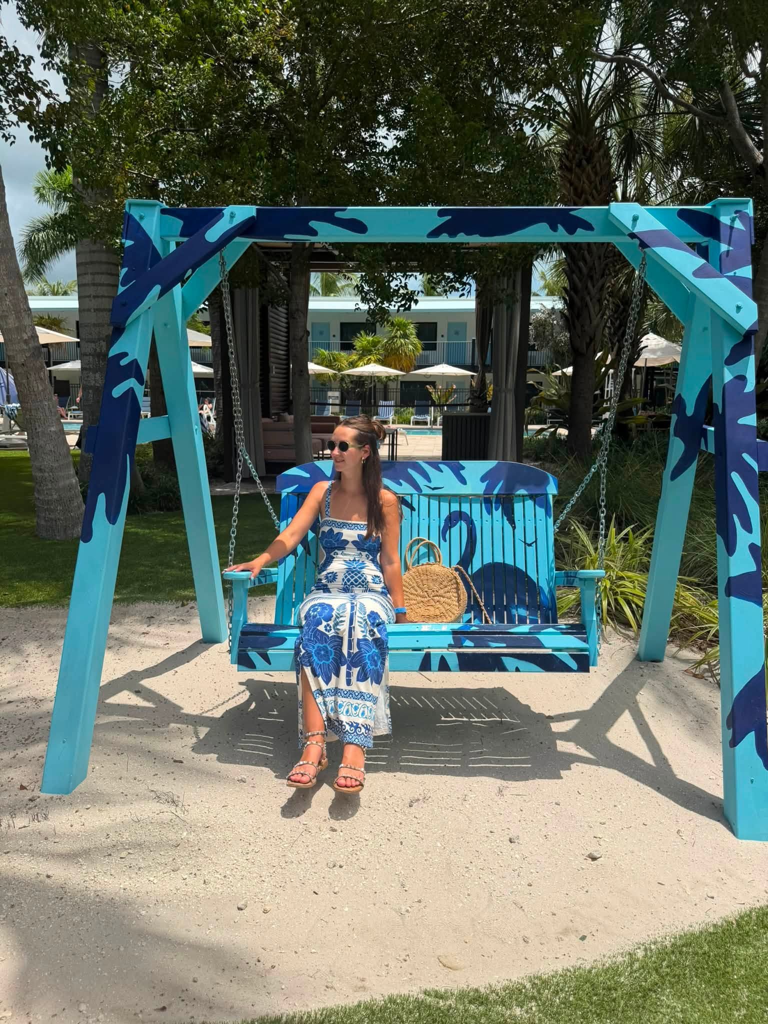 woman sitting on swing in The Backyard at Blue Flamingo Resort