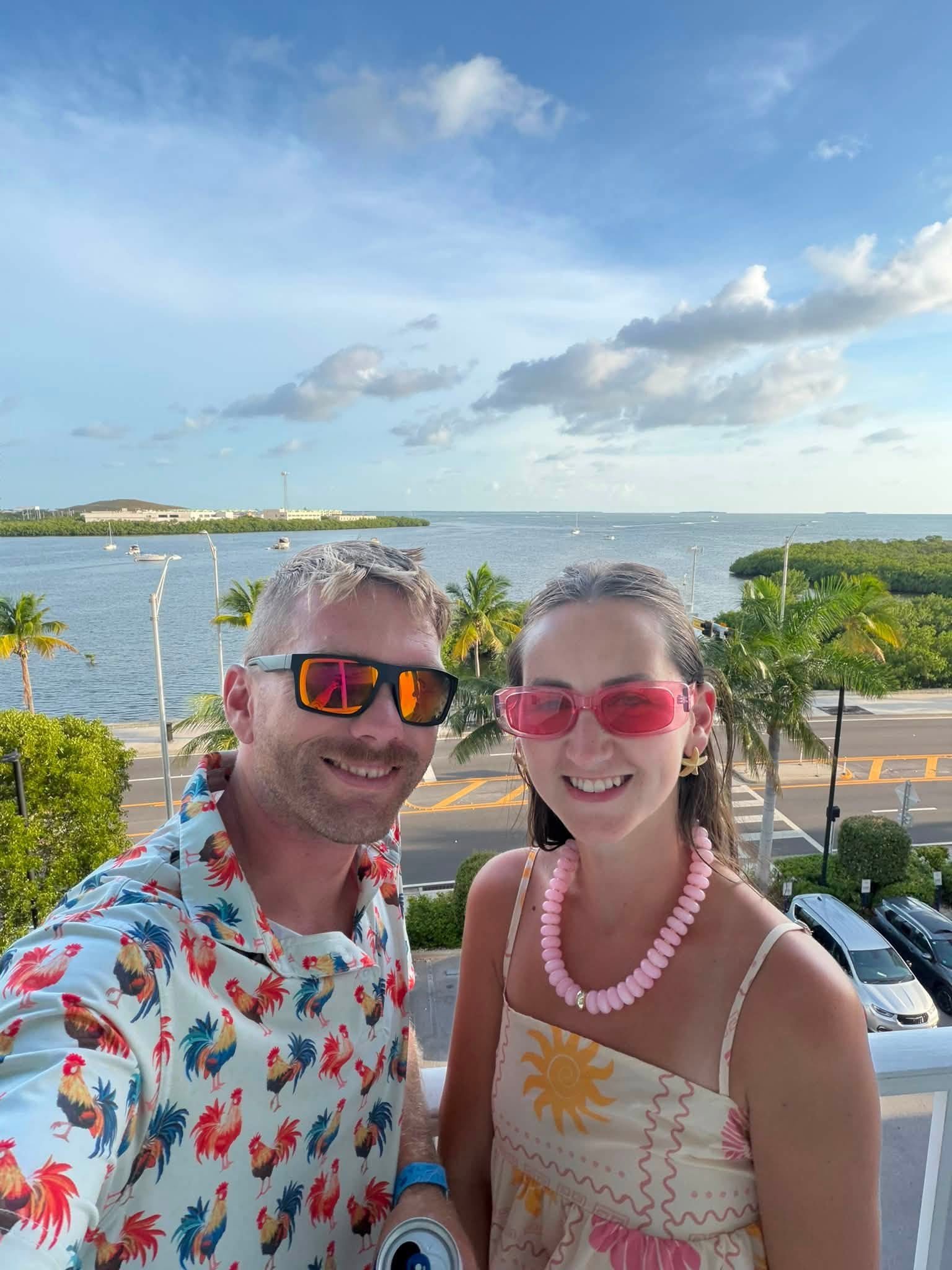 photo of husband and wife with the ocean in the background