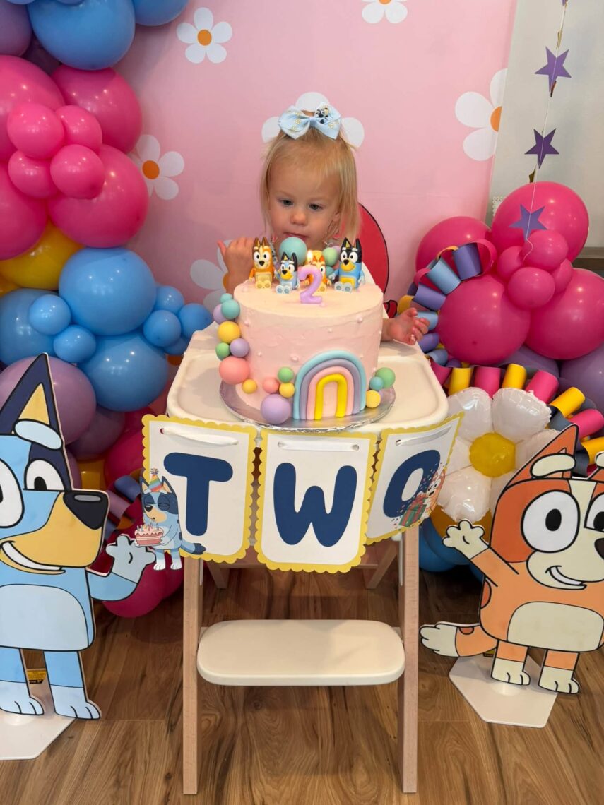 birthday girl with Bluey birthday cake